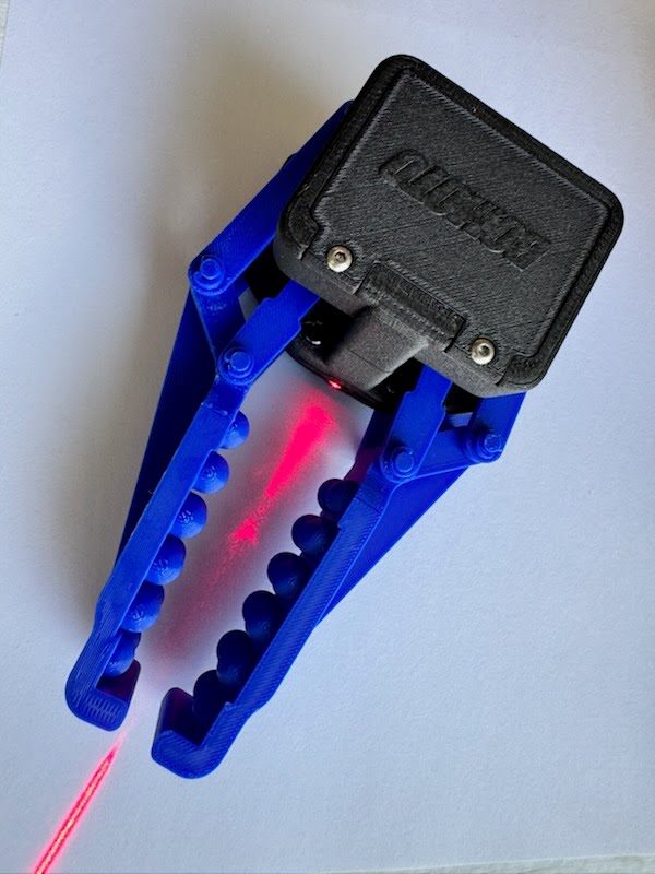 Plitzie EOD sensor module mounted on a blue robotic gripper, projecting a laser line